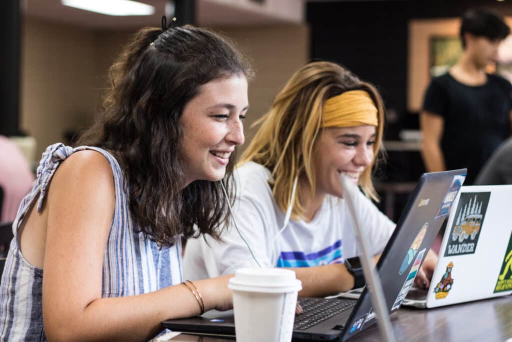 two Toccoa Falls College students using their laptops