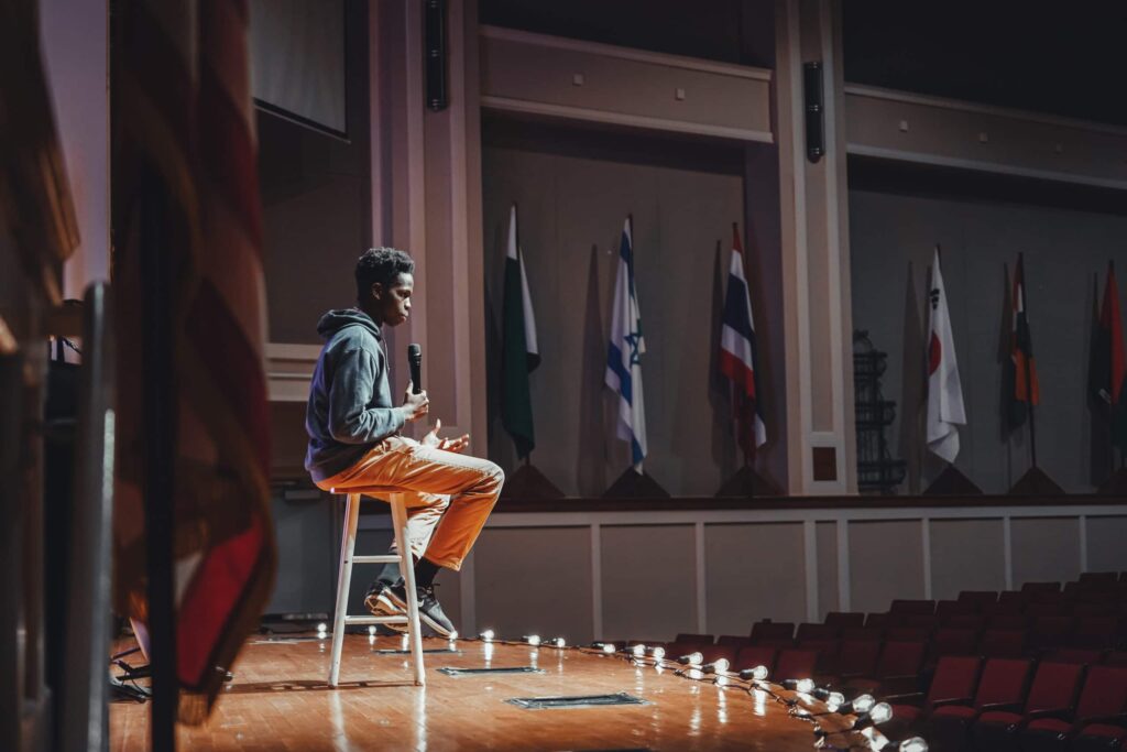 student on stage with microphone