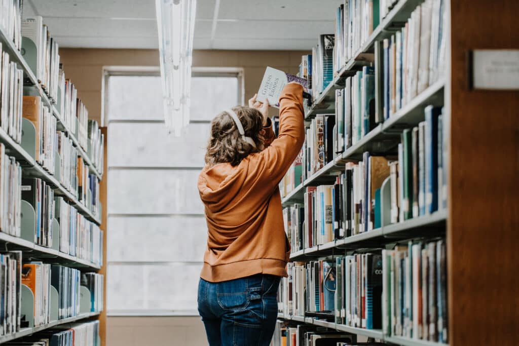 A student picking out a book.