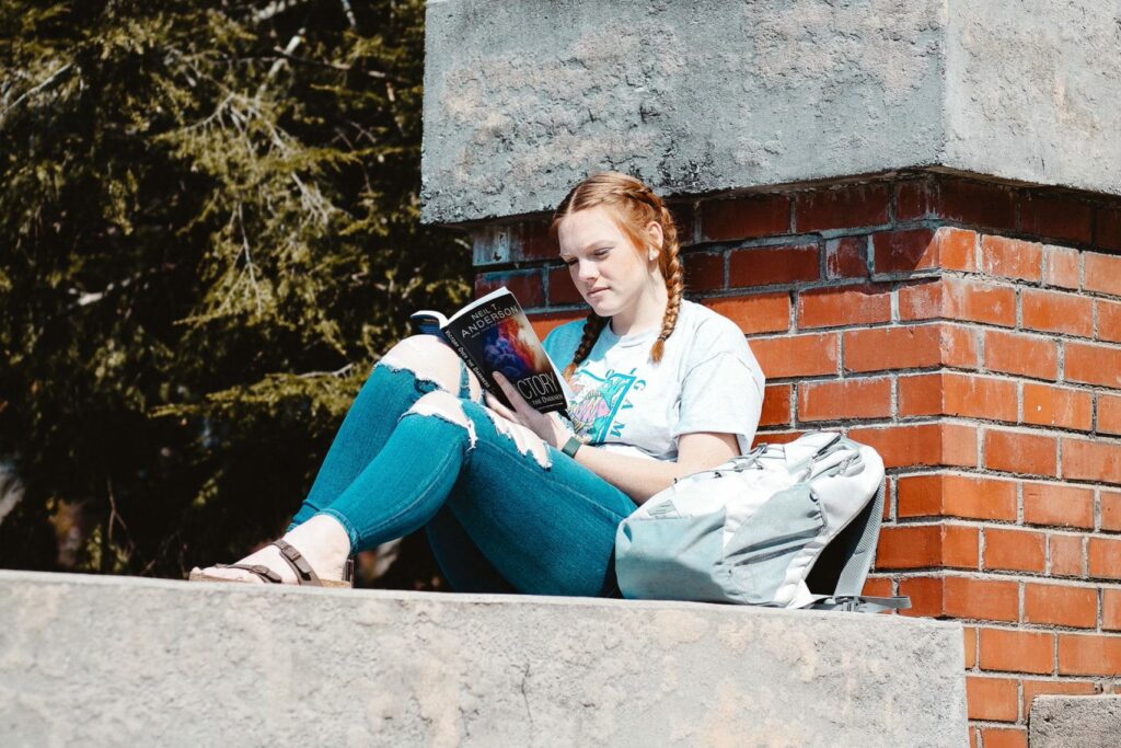 Student reading on campus
