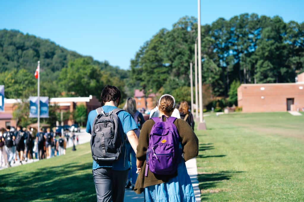 students walking back on IM field sidewalk.