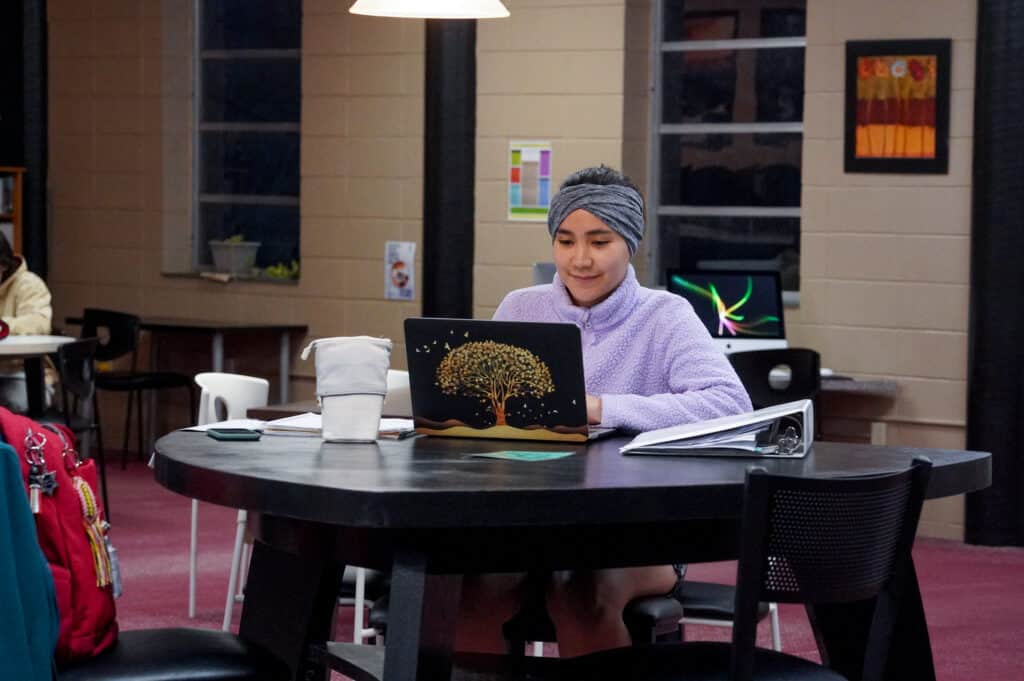 young woman using her laptop at a desk