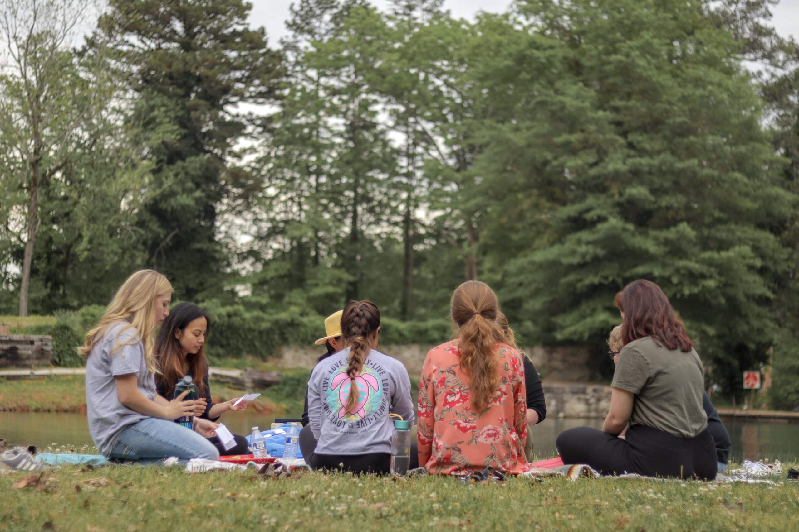 Toccoa Falls College students having class outside by a pond