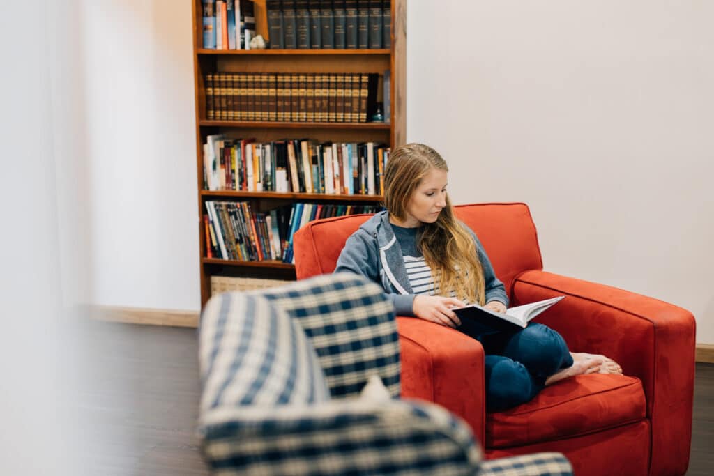 Student reading in a chair