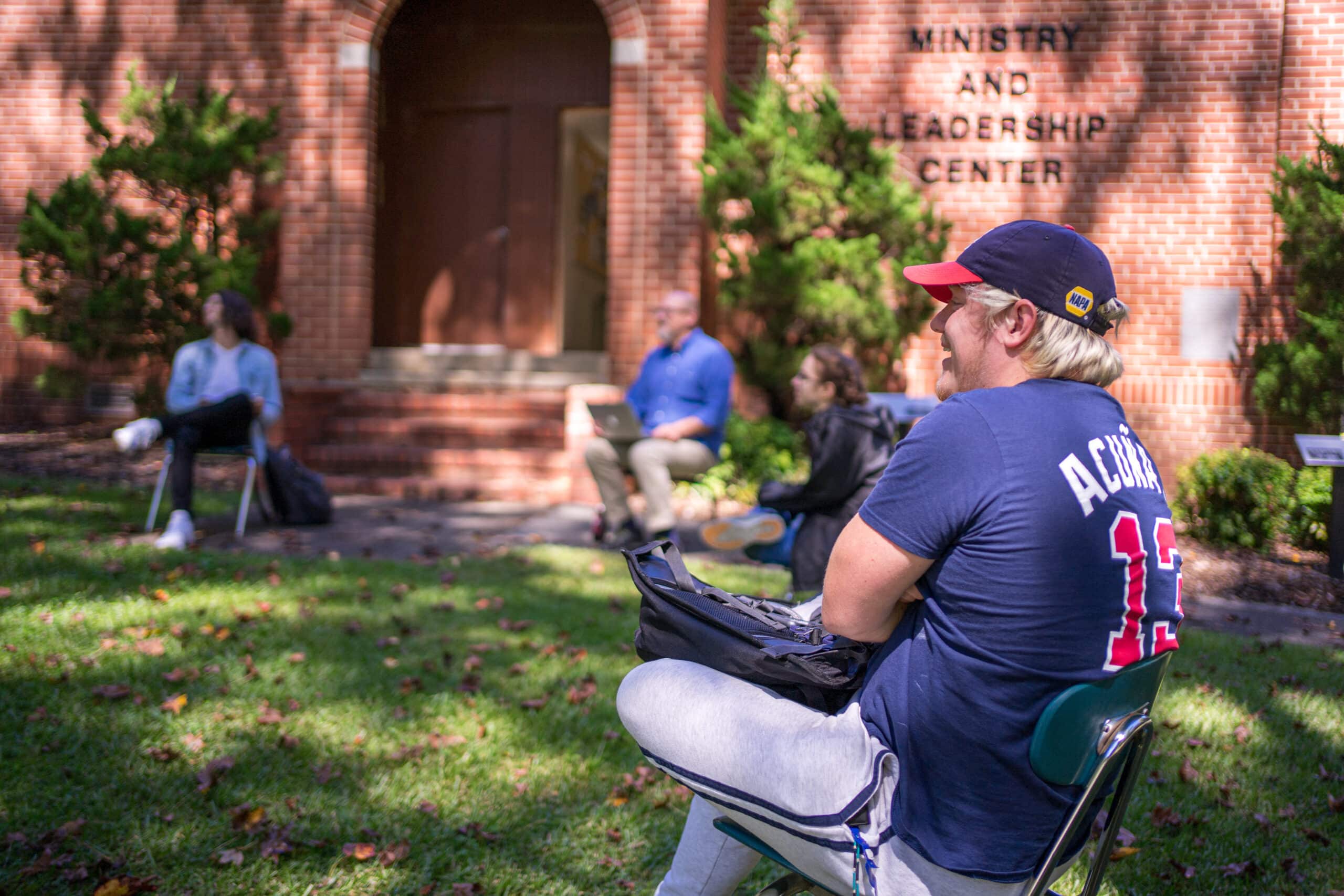 Toccoa Falls College students having class outside in spring