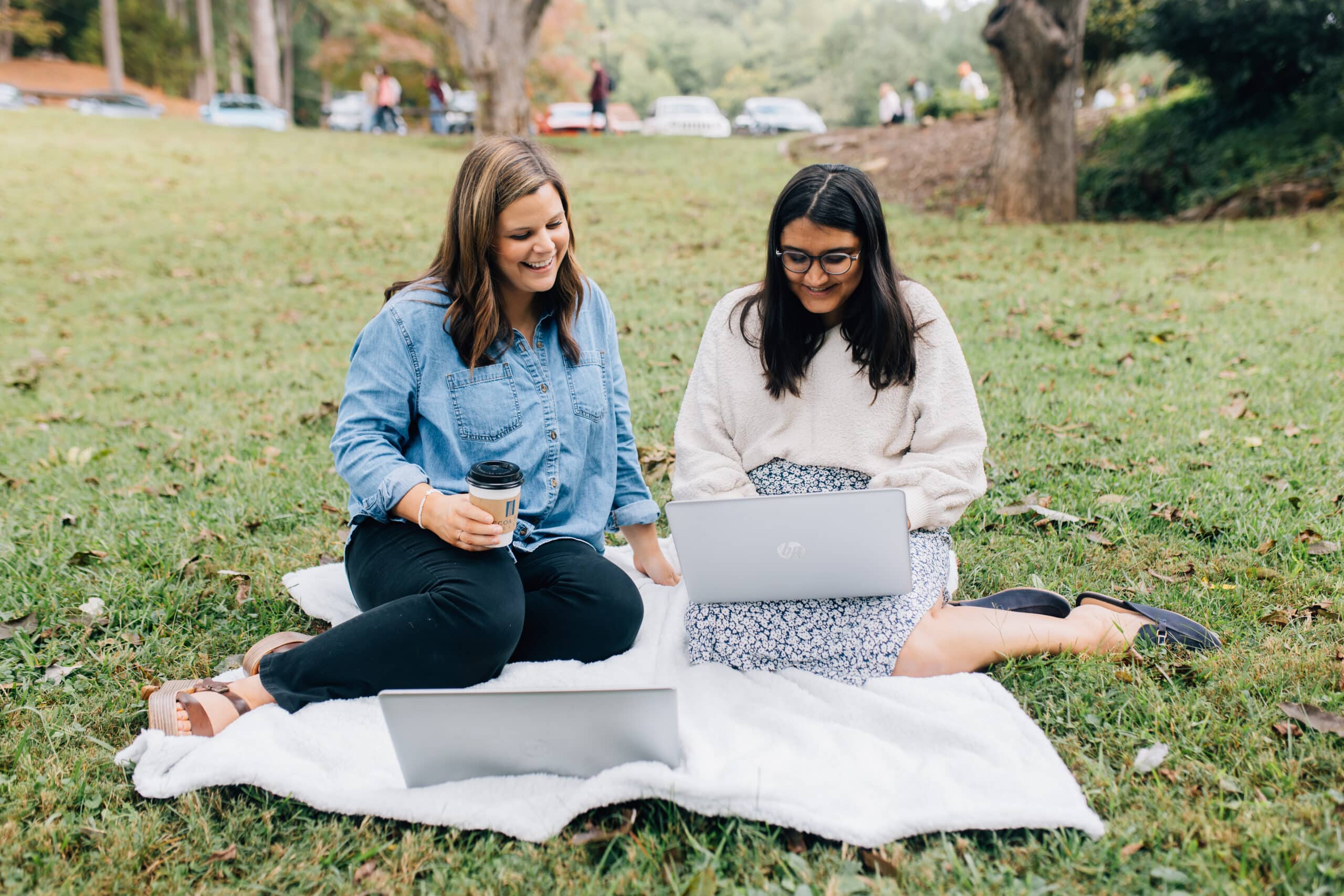 Students smiling looking at laptop