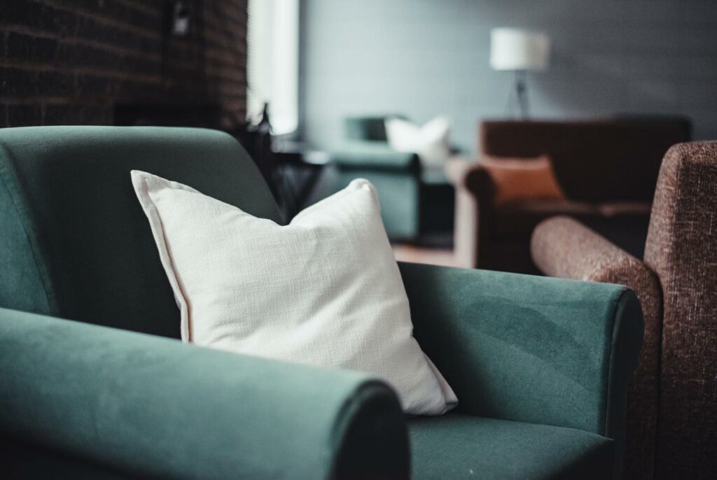 A green chair sits in a rec room