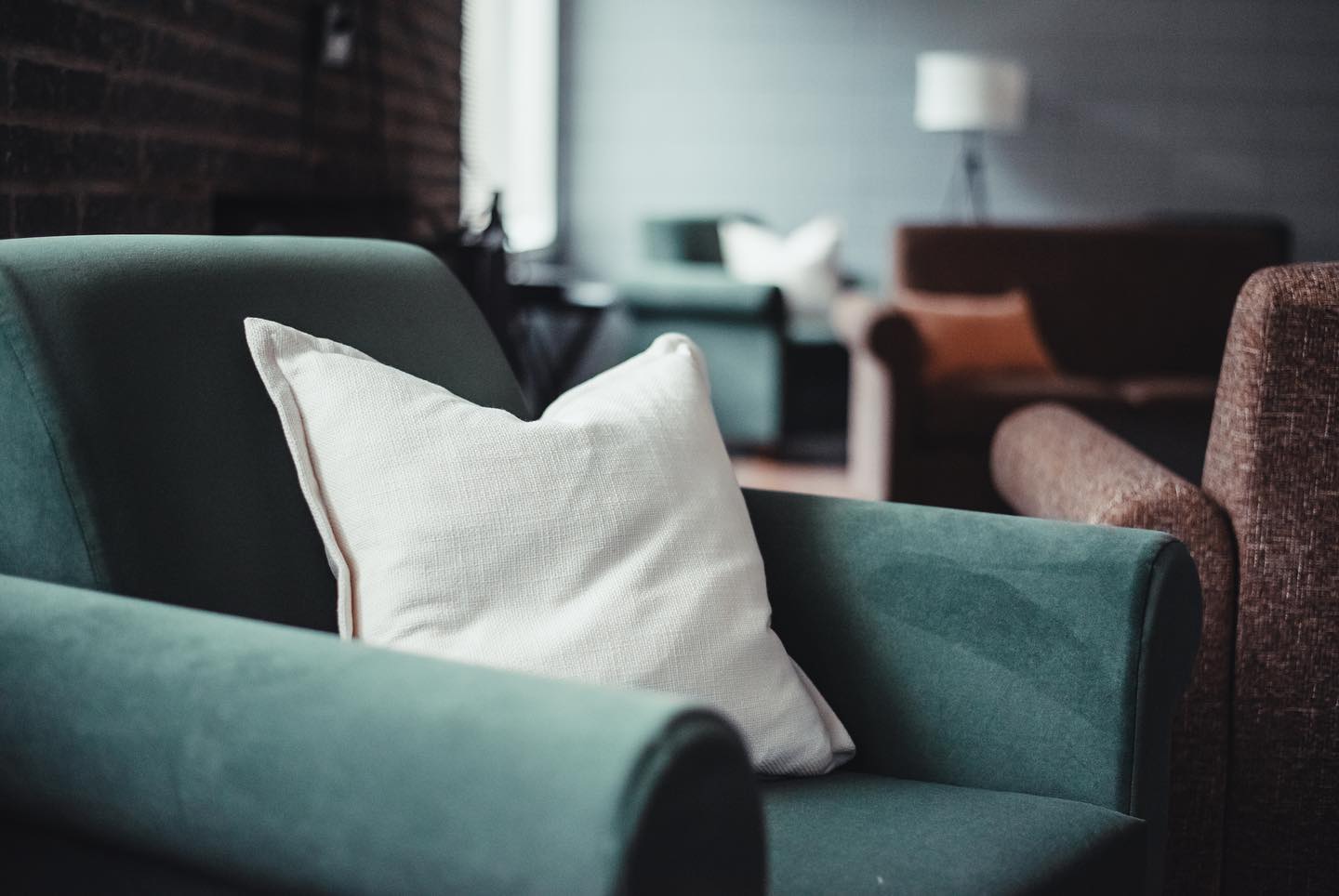 A green chair sits in a rec room