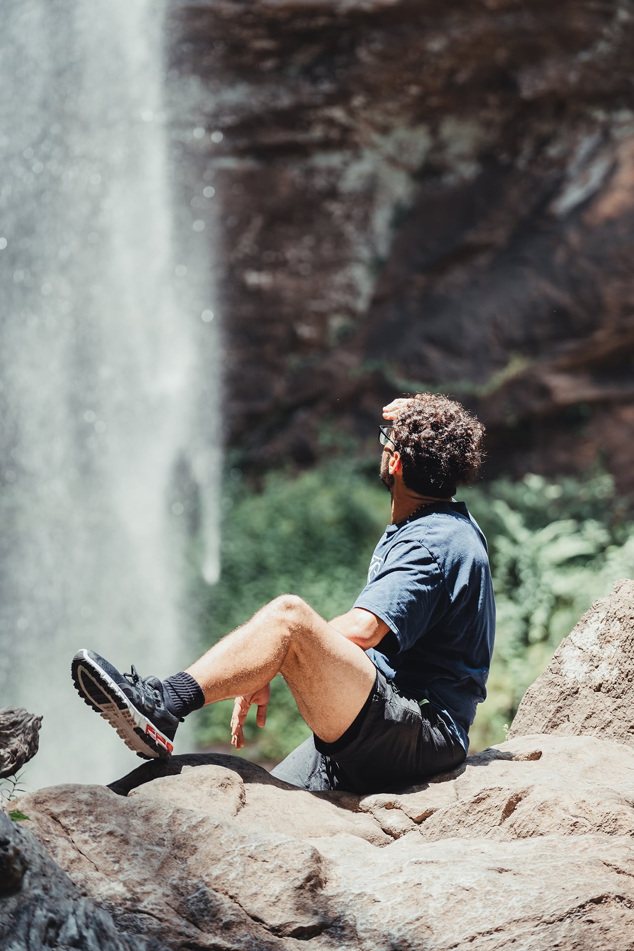 A young man admires The Toccoa Waterfall