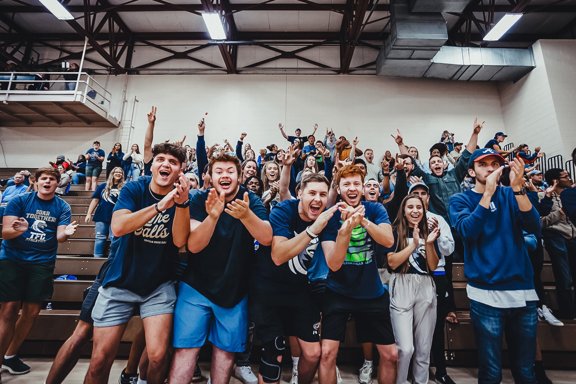 Toccoa Falls College Students cheer in a gym