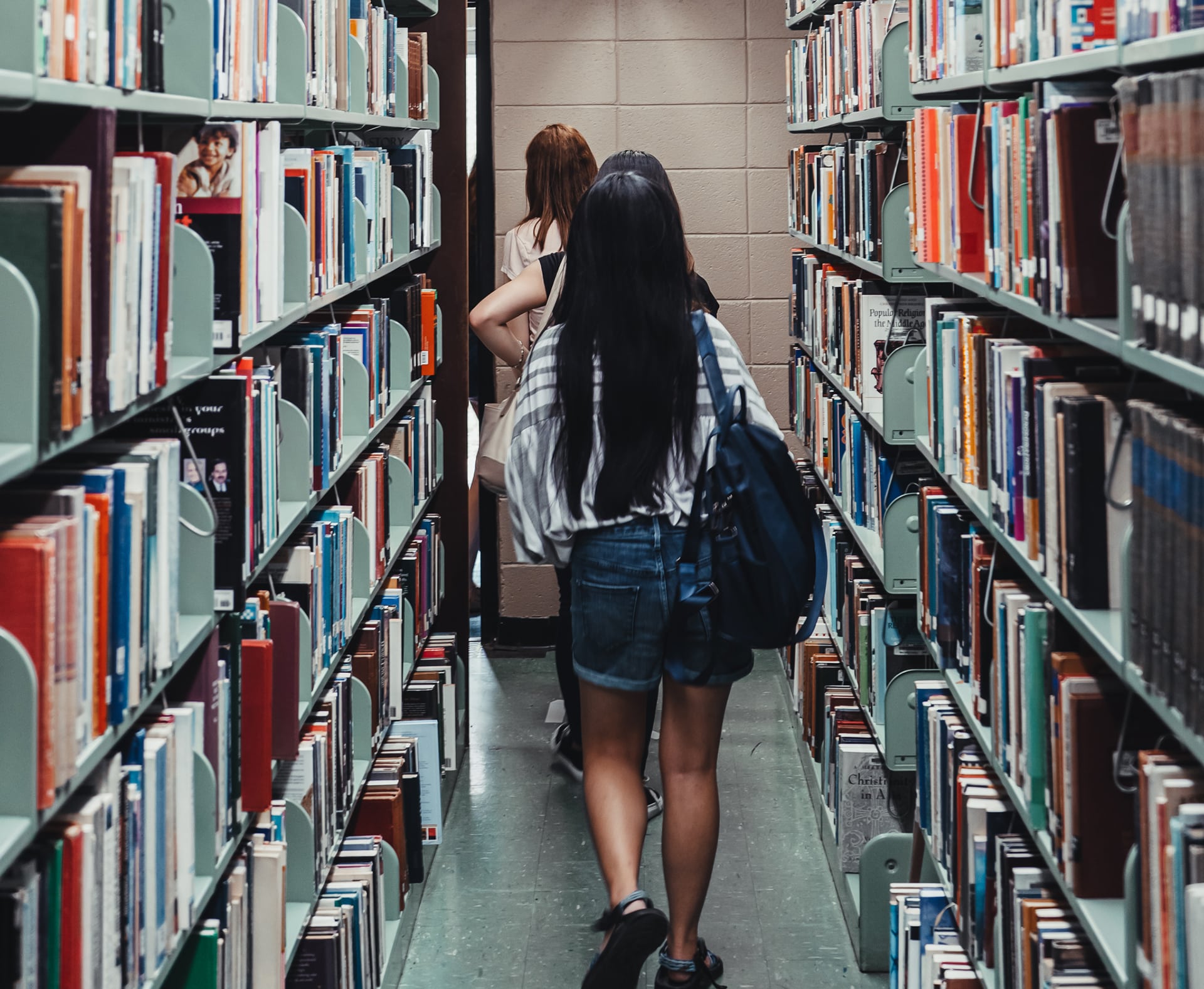 Toccoa Falls College students walk through a library