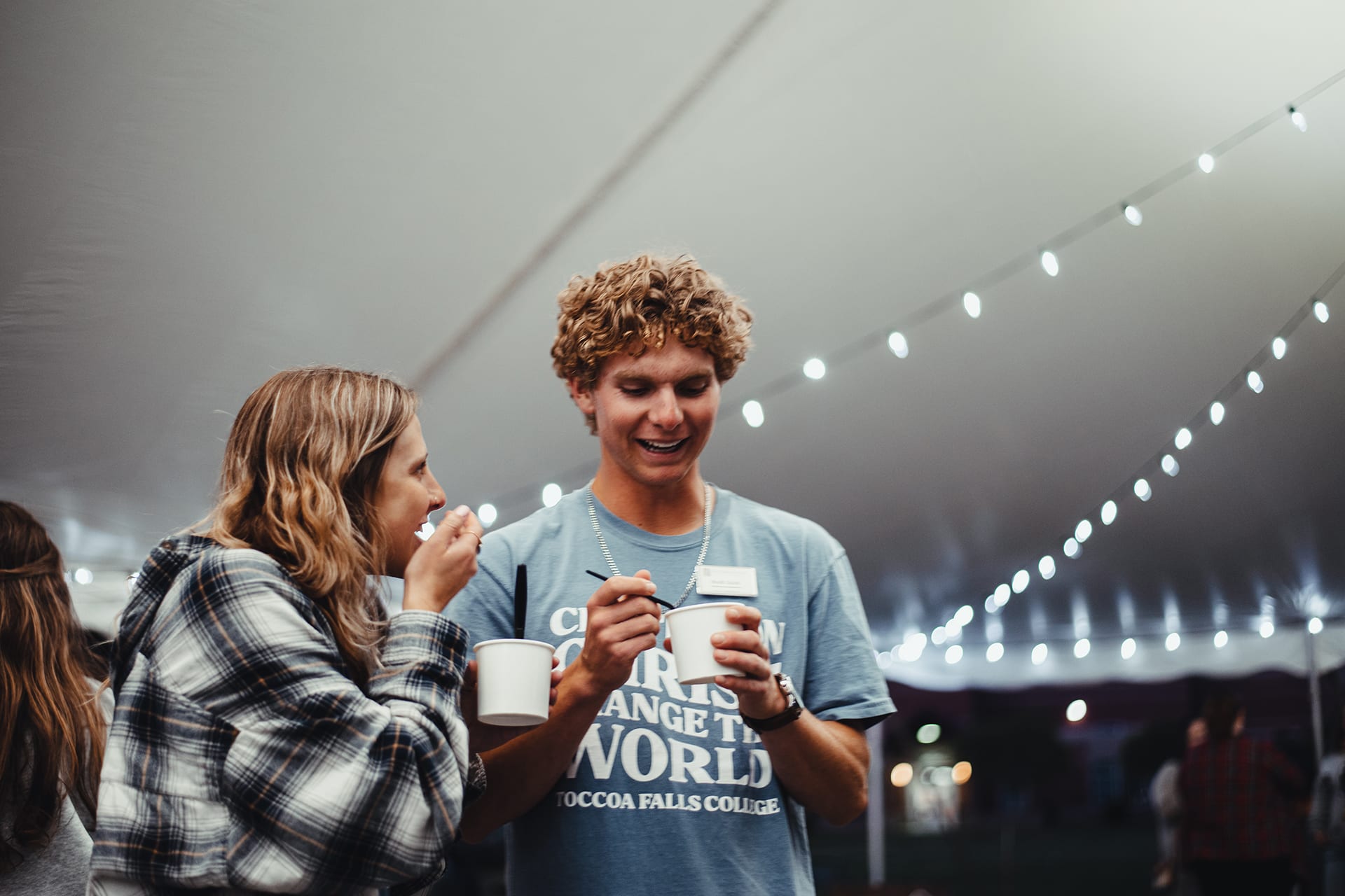 Two Toccoa Falls College students smile and eat ice cream
