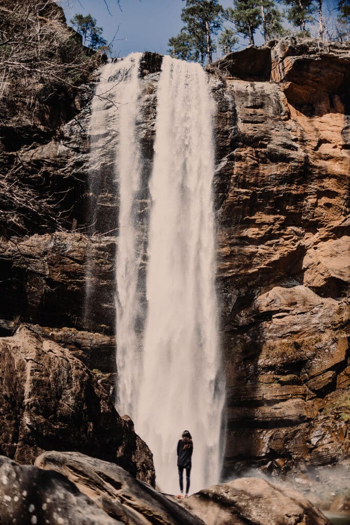 A young lady admires The Toccoa Waterall