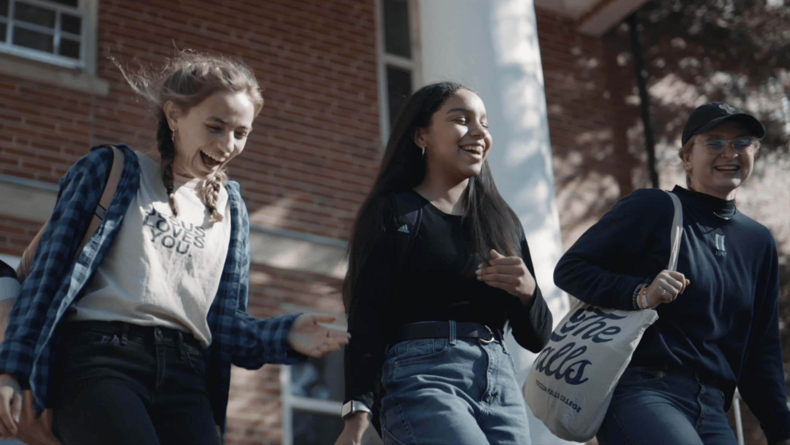 Toccoa Falls students smiling, exiting a building