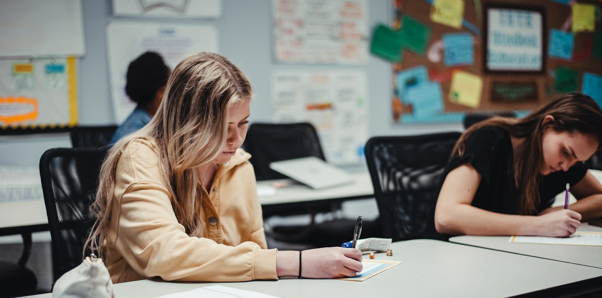 Toccoa Falls College students working at a desk