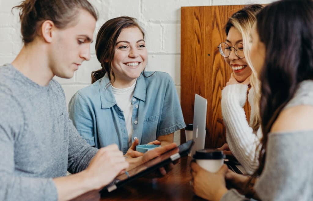 Smiling young people sitting at a table