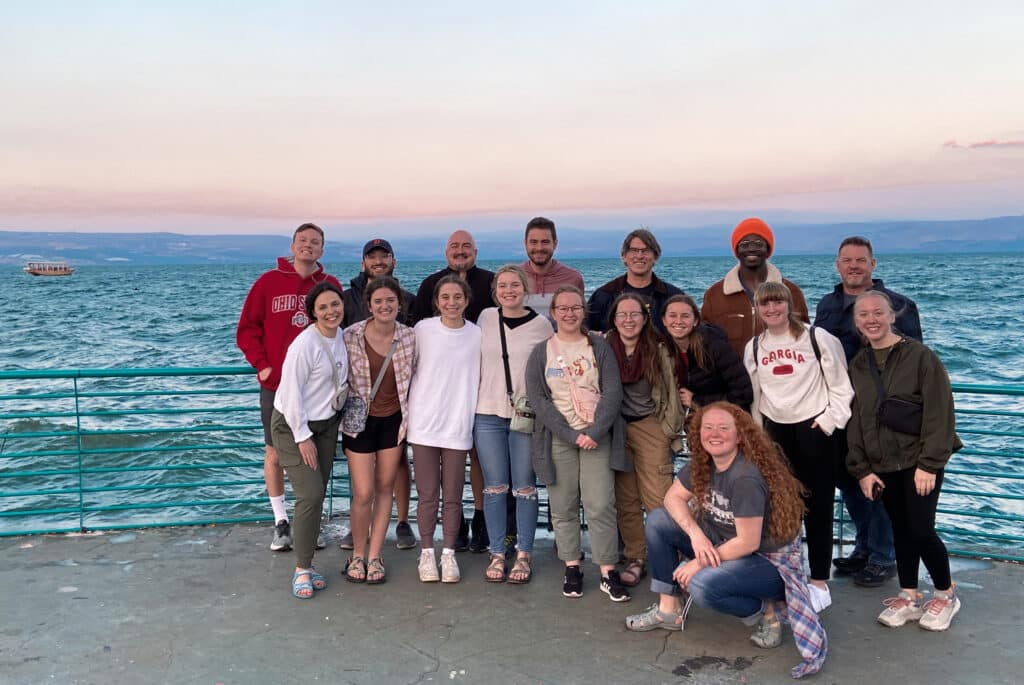 Students standing beside water in Israel