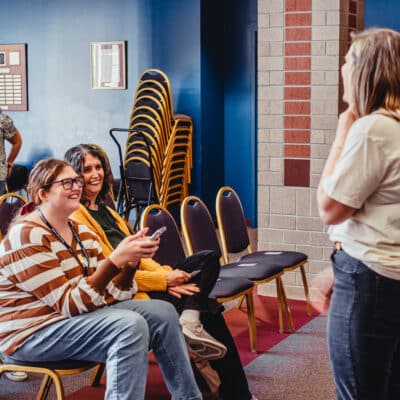 Toccoa Falls College Students sit, laughing in a classroom