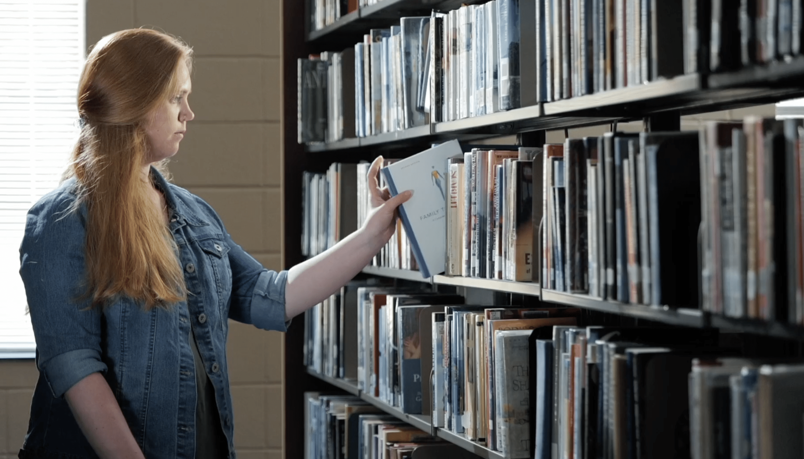 female-student-selecting-book