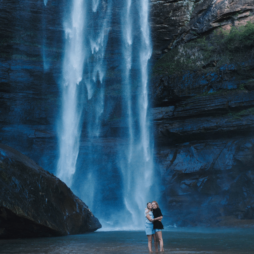 students at bottom of waterfall