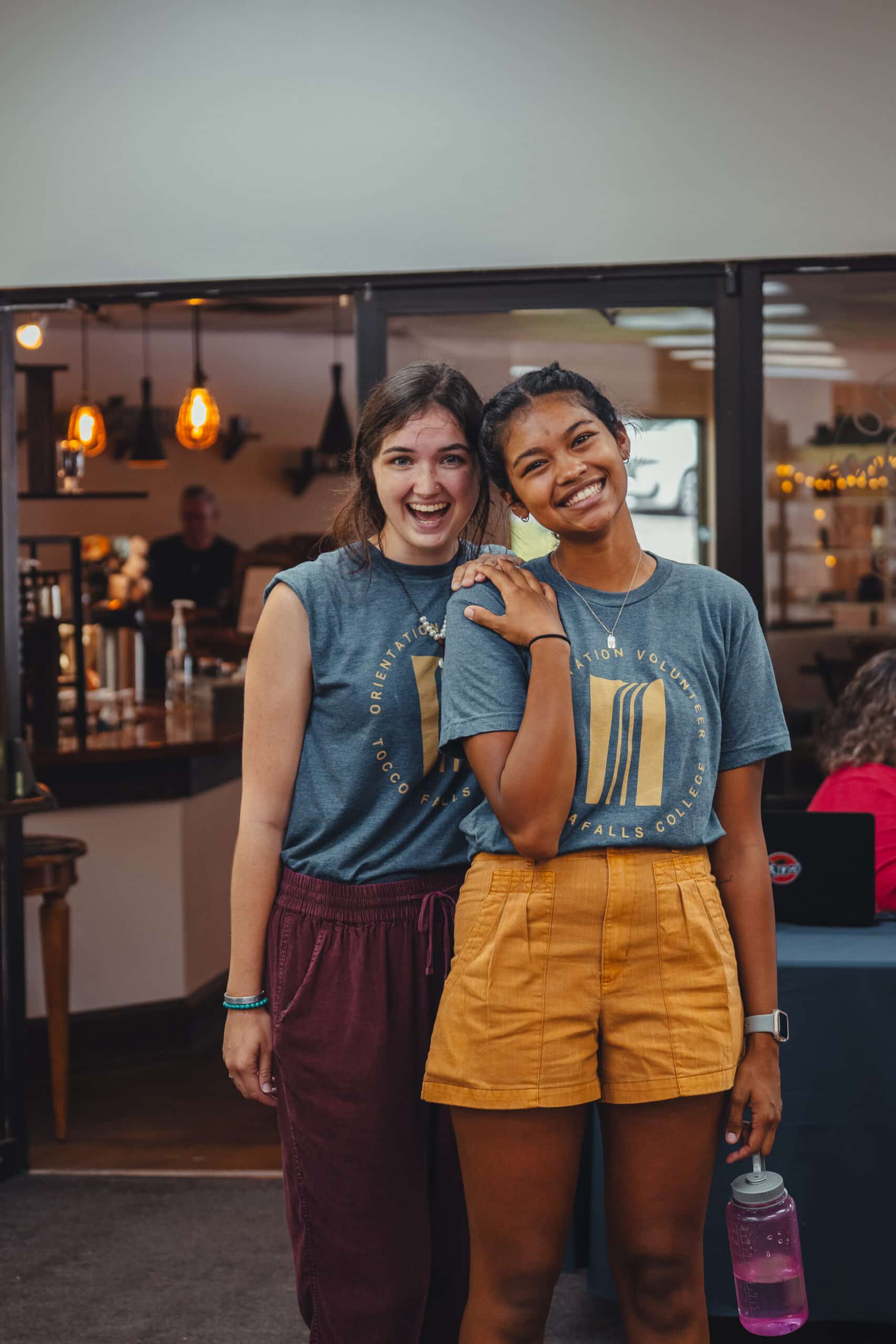 students with matching tfc shirts in a dining area