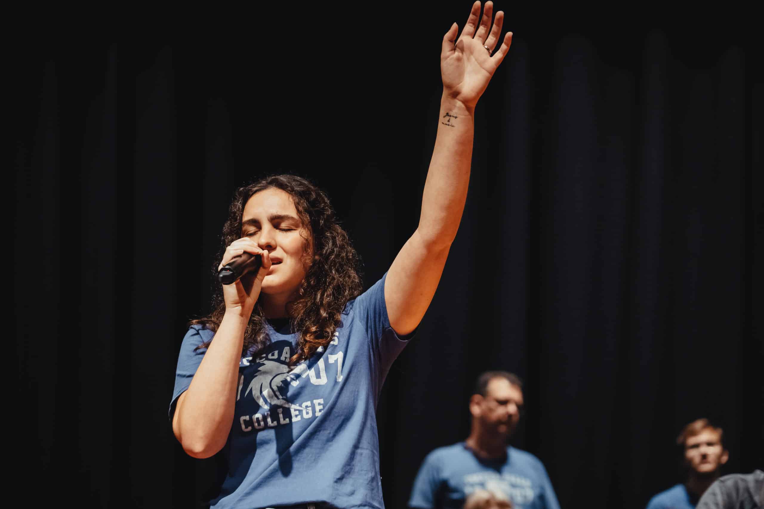 student leading worship