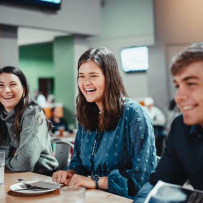 Students smiling in dining hall