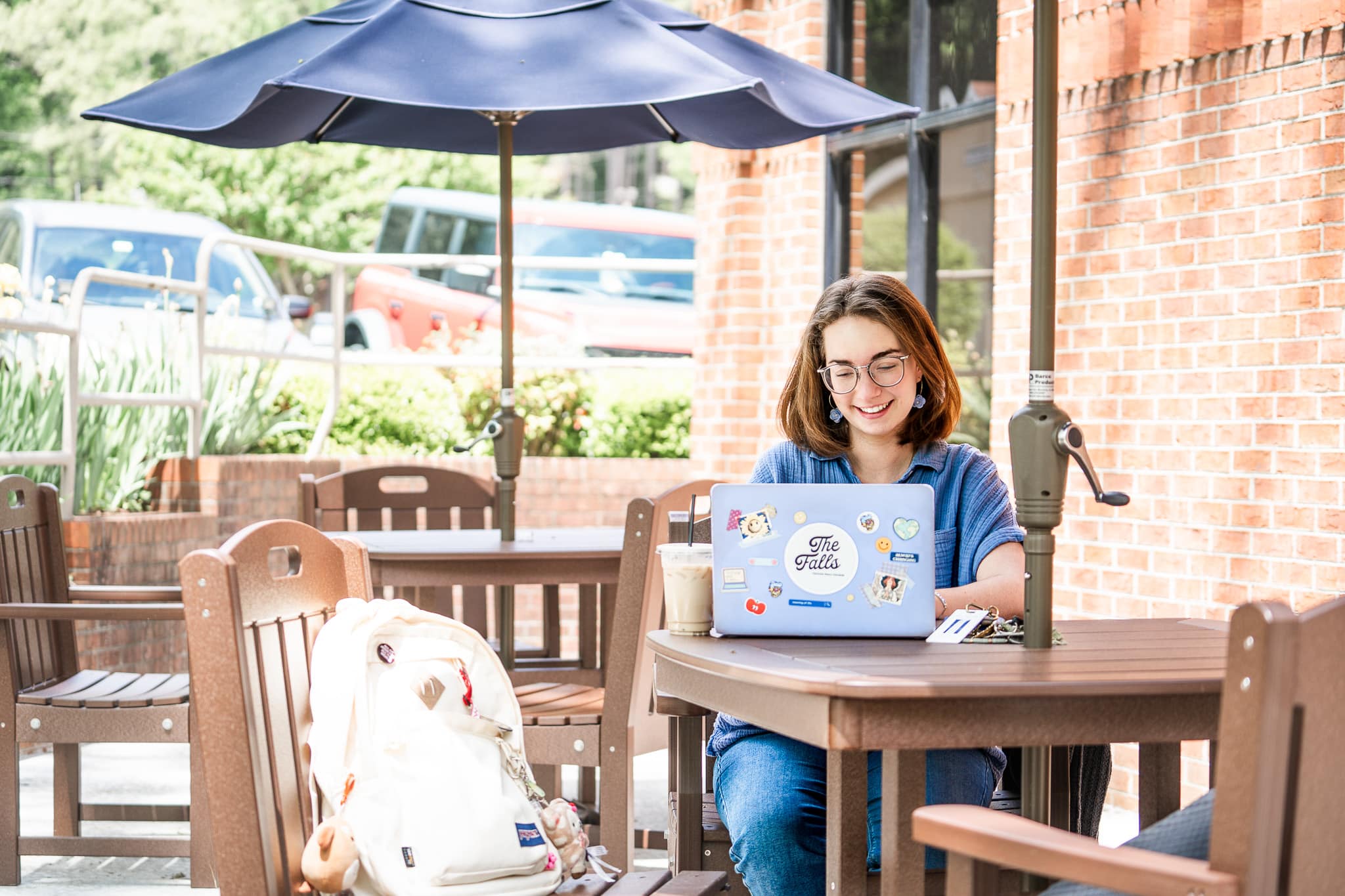 student smiling working on laptop