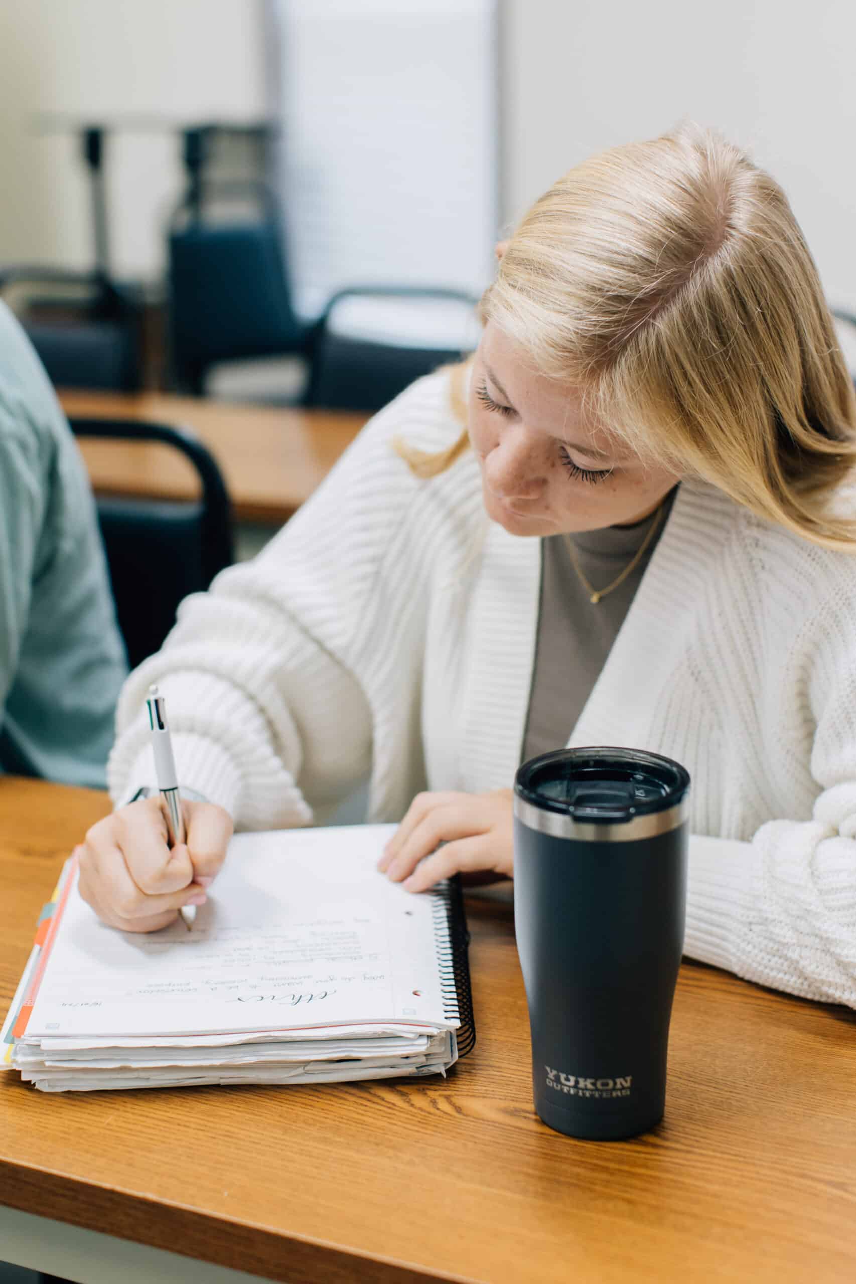 Student taking notes in class