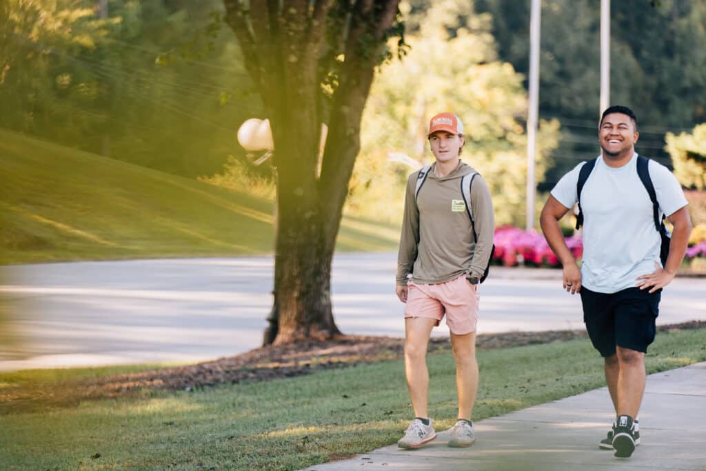 Students walking and smiling outside