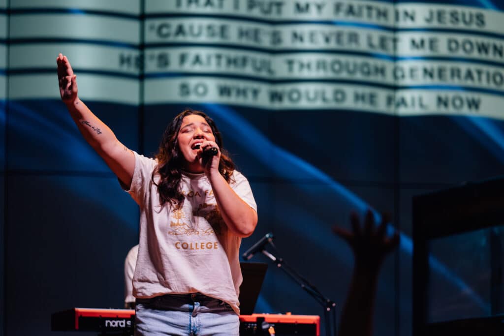 A young lady singing on stage