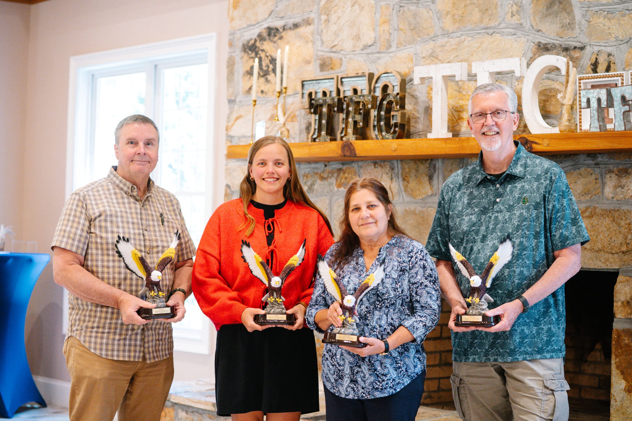 People posing with awards