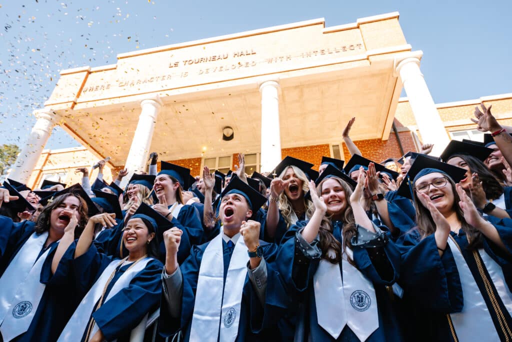 students celebrating in cap and gown
